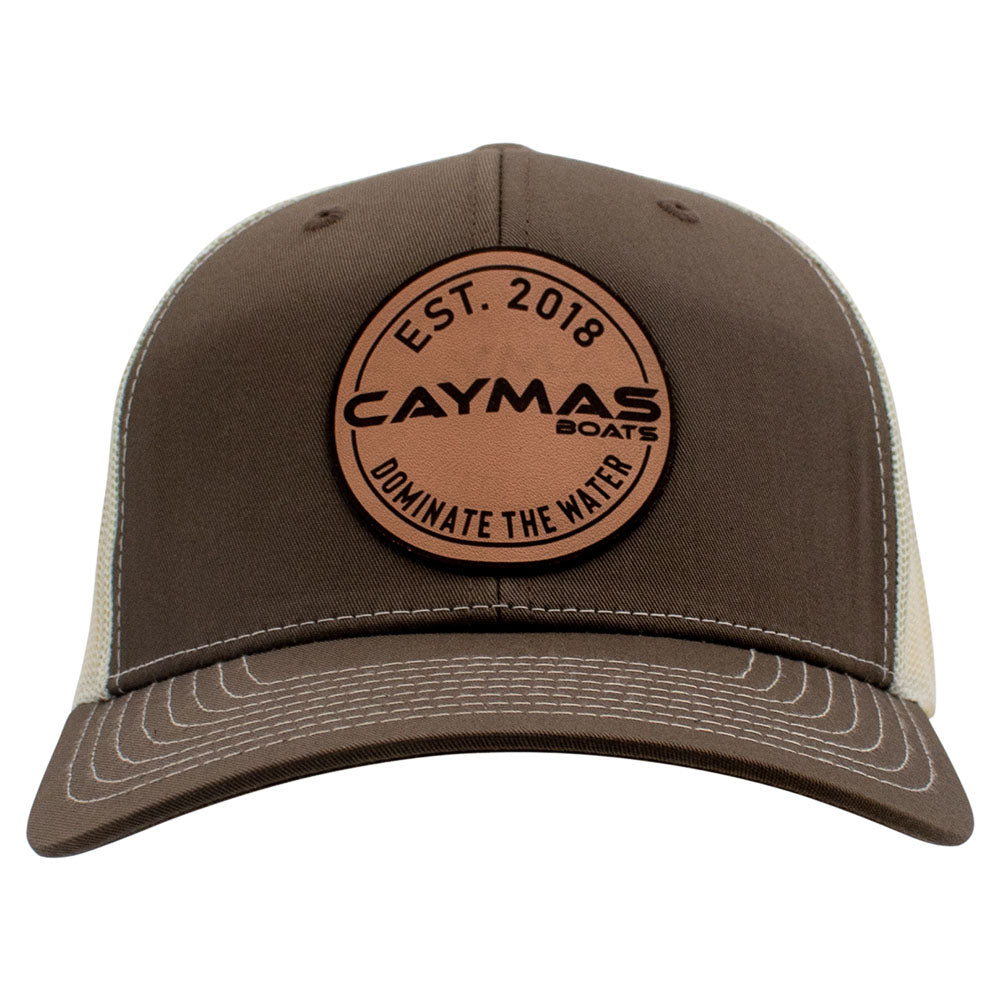 Front of a brown and beige cap with a circular Caymas Boats patch.