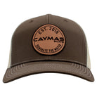 Front of a brown and beige cap with a circular Caymas Boats patch.