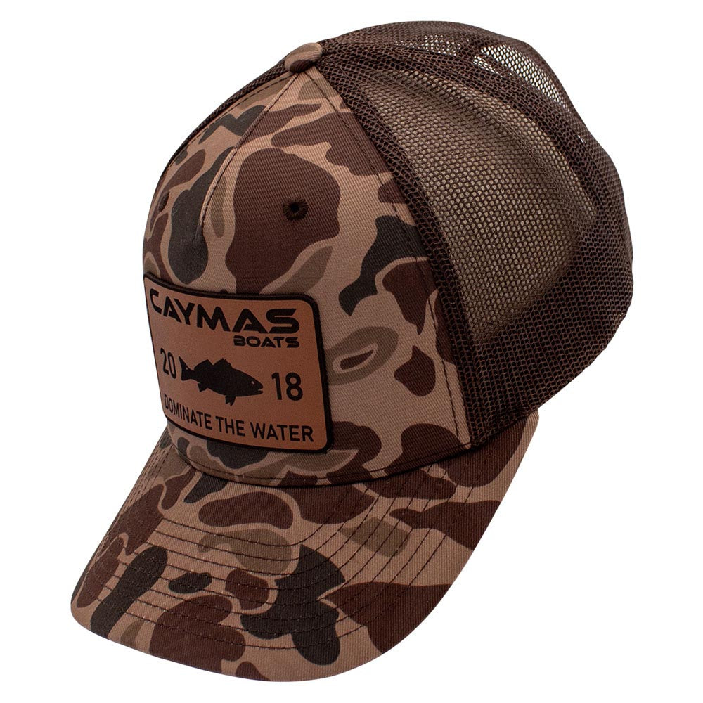 Side of a brown camouflage cap with Caymas Boats logo patch on the front. 